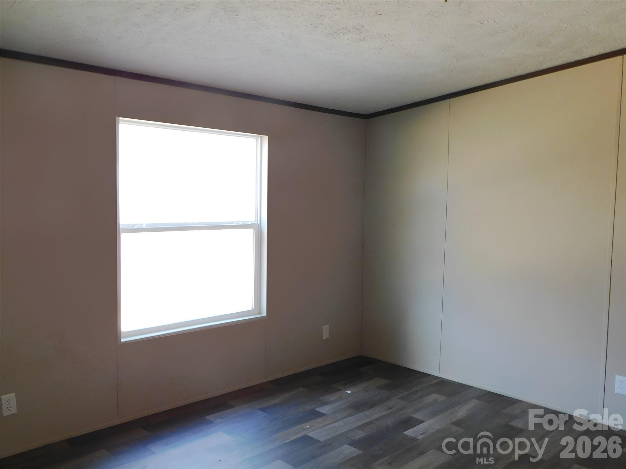 149 Bramble Trail Salisbury, NC 28144 - Photo 18 of 27 an empty room with wooden floor and windows