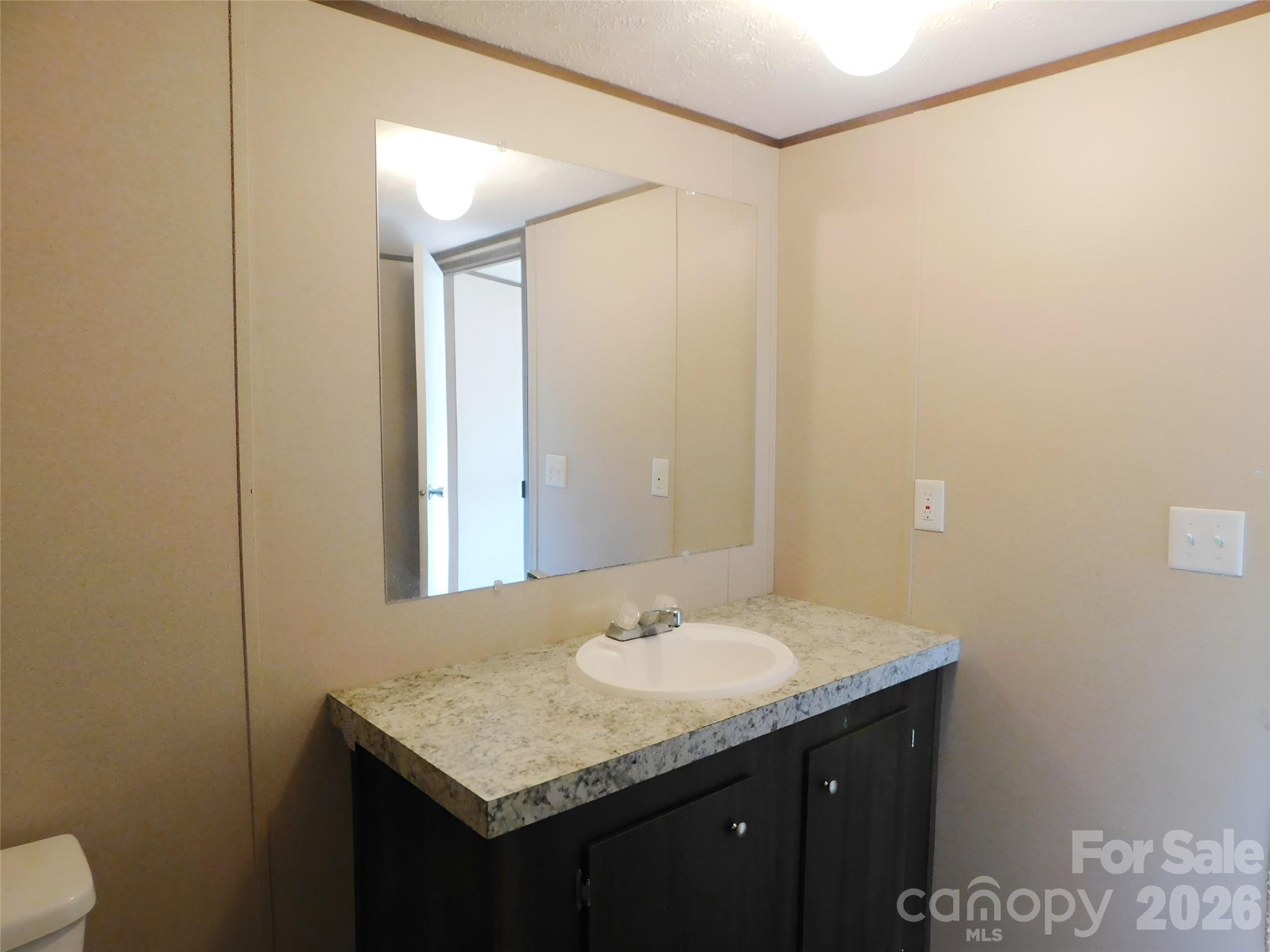 149 Bramble Trail Salisbury, NC 28144 - Photo 19 of 27 a bathroom with a granite countertop sink and a mirror