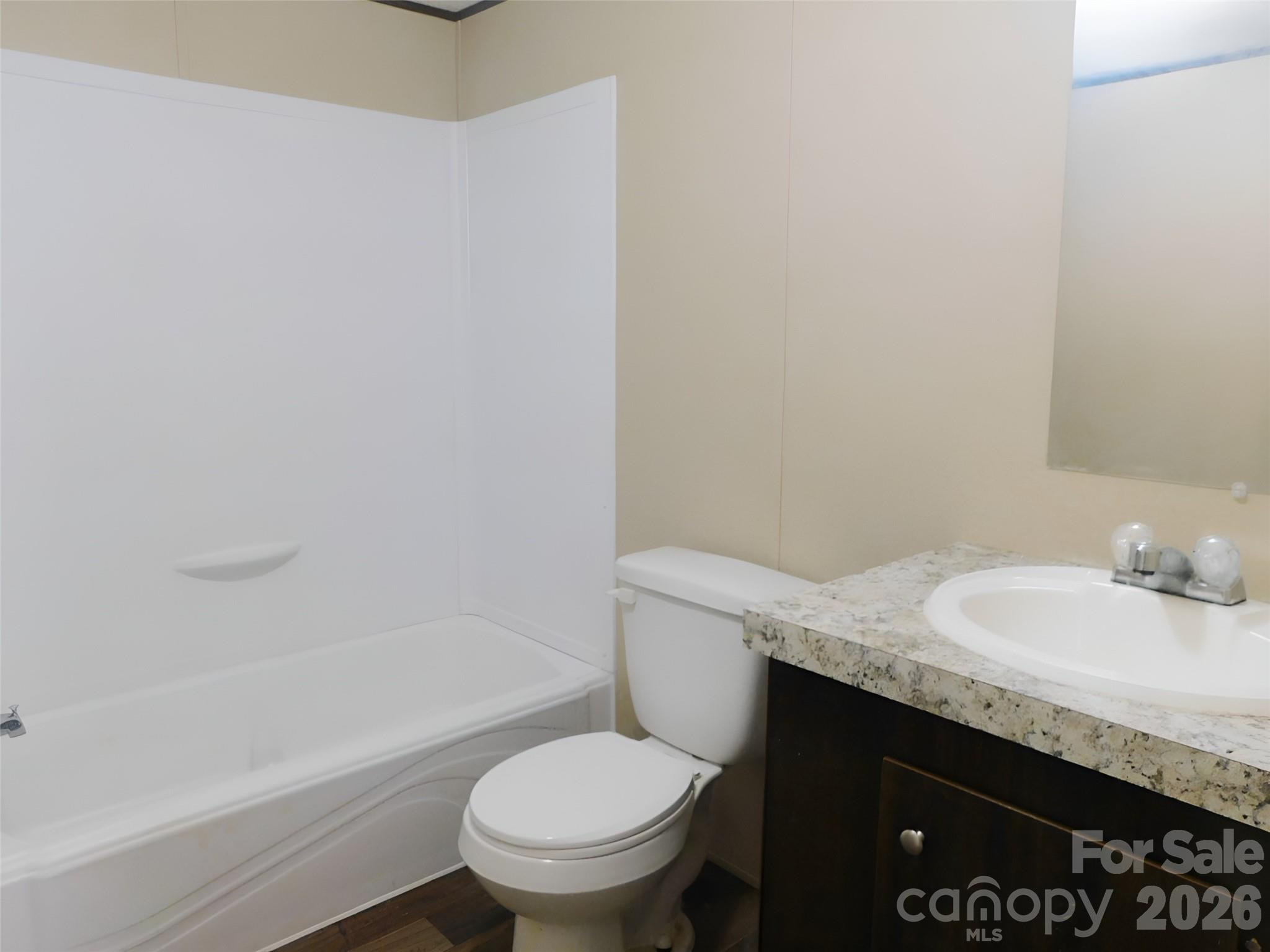 149 Bramble Trail Salisbury, NC 28144 - Photo 21 of 27 a bathroom with a granite countertop sink and a toilet