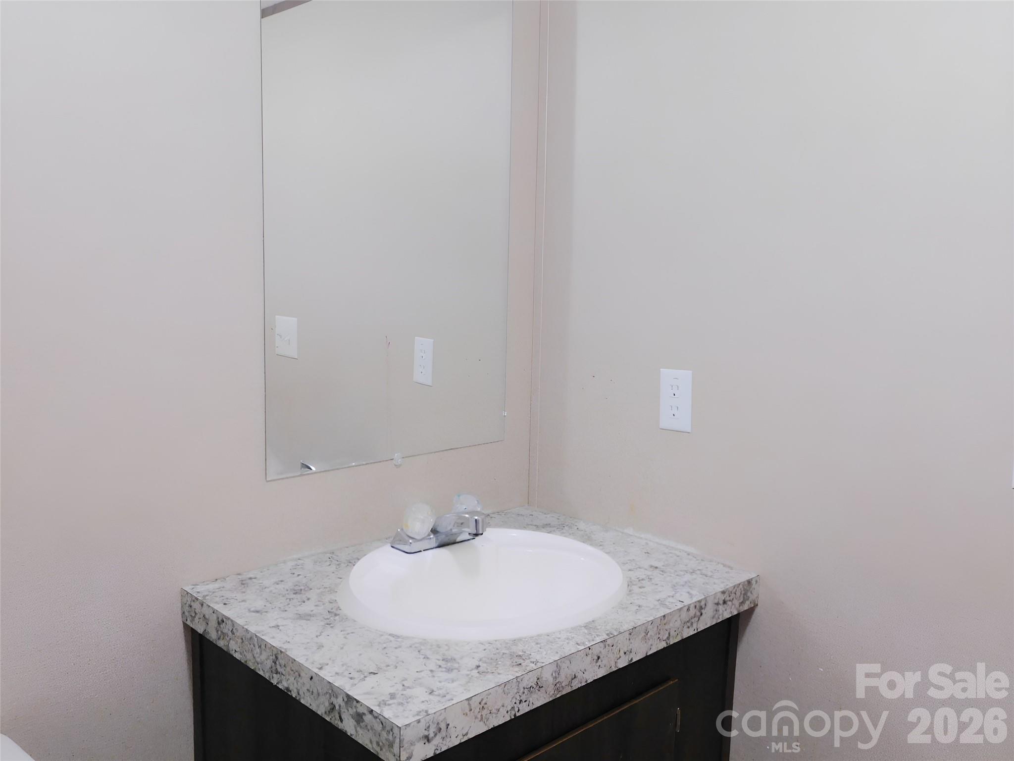 149 Bramble Trail Salisbury, NC 28144 - Photo 23 of 27 a bathroom with a granite countertop sink and a mirror