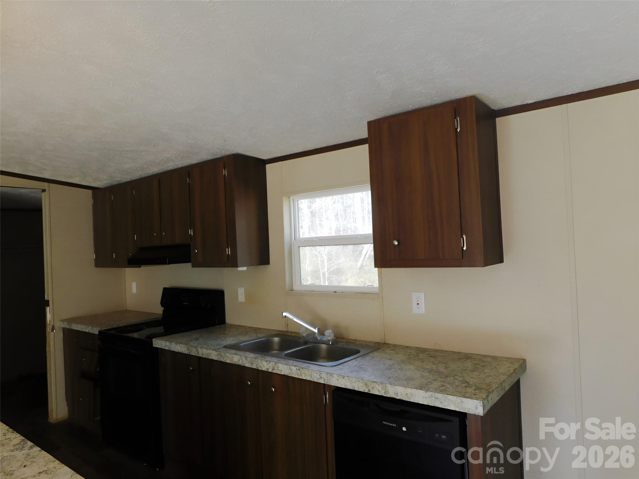 149 Bramble Trail Salisbury, NC 28144 - Photo 7 of 27 a kitchen with a sink a window and cabinets