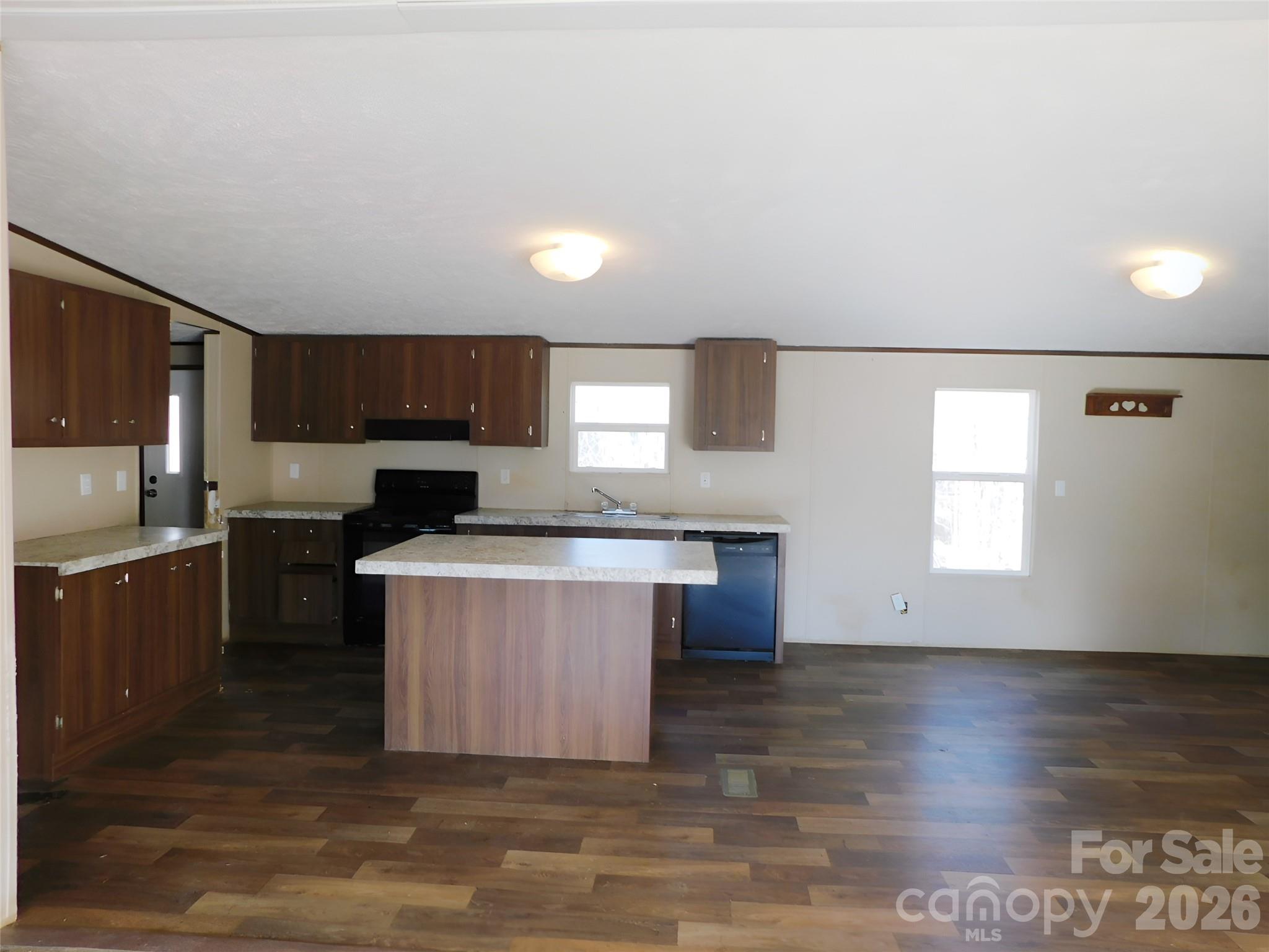 149 Bramble Trail Salisbury, NC 28144 - Photo 8 of 27 a kitchen with stainless steel appliances granite countertop a stove a sink and a microwave