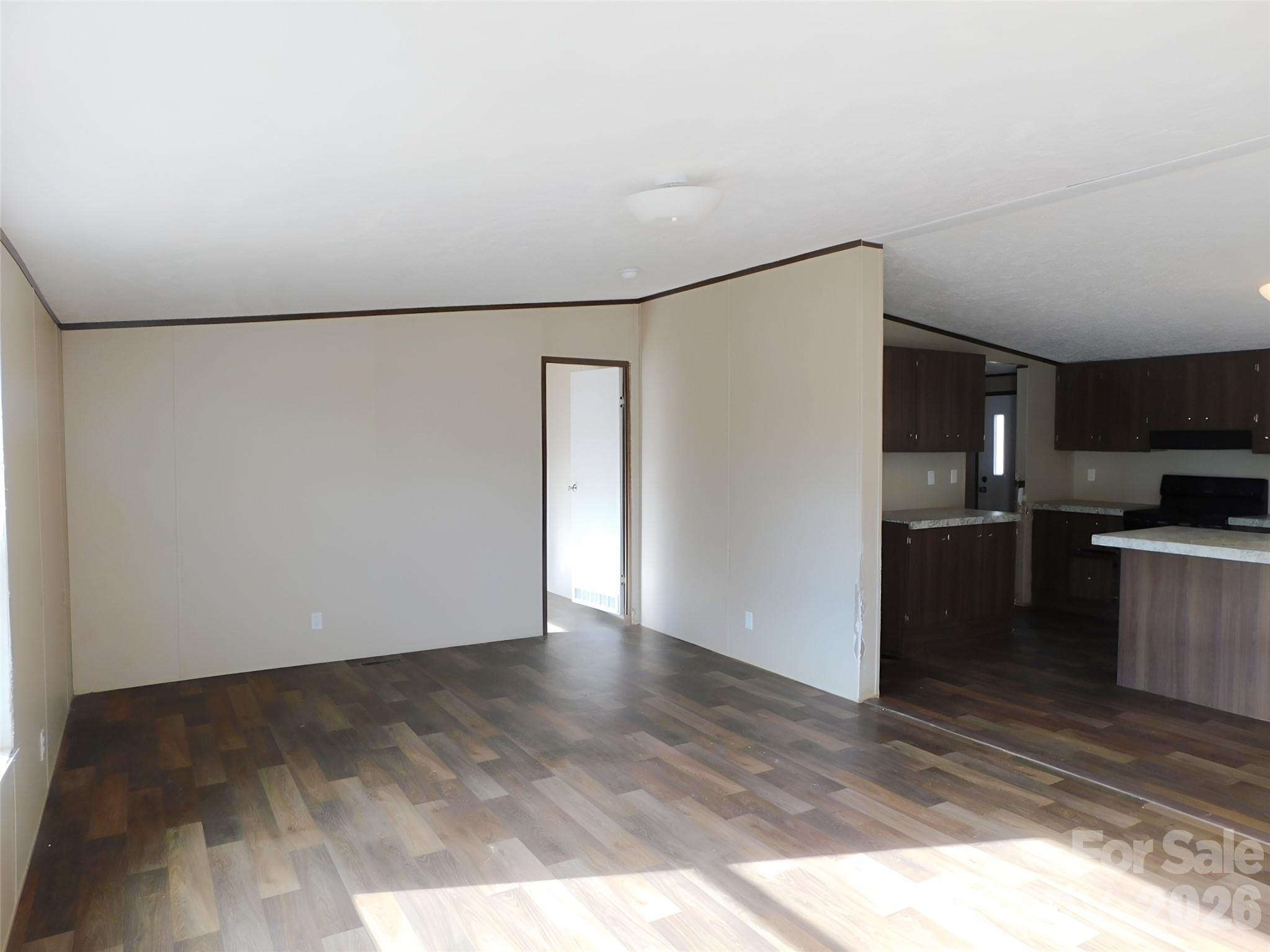 149 Bramble Trail Salisbury, NC 28144 - Photo 10 of 27 a view of a kitchen with a refrigerator a stove top oven and a dishwasher with wooden floor