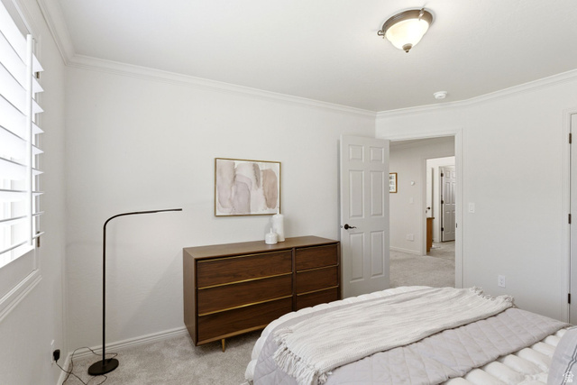 1712 Somerset Ridge Drive Draper, UT 84020 - Photo 49 of 76 Bedroom featuring white interior walls, white crown molding, white plantation shutters, and light gray carpet flooring