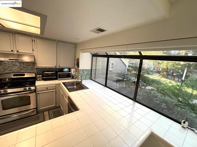 a kitchen that has a sink and a stove