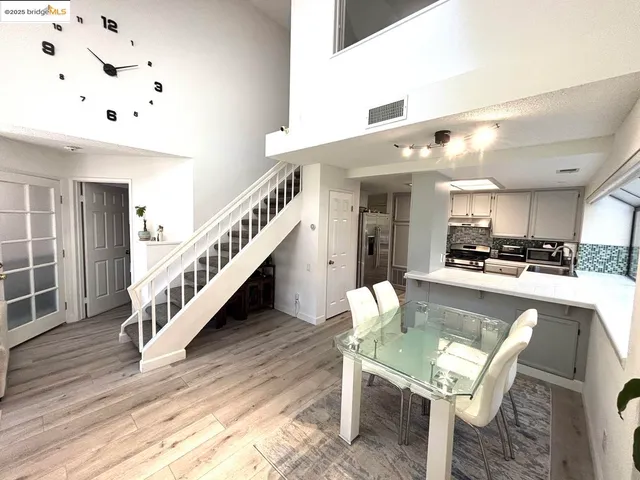 a dining room with furniture and wooden floor