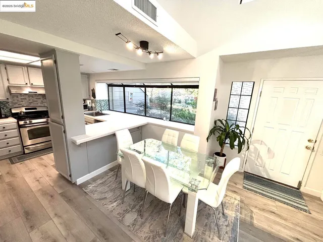 a dining room with furniture a window and wooden floor