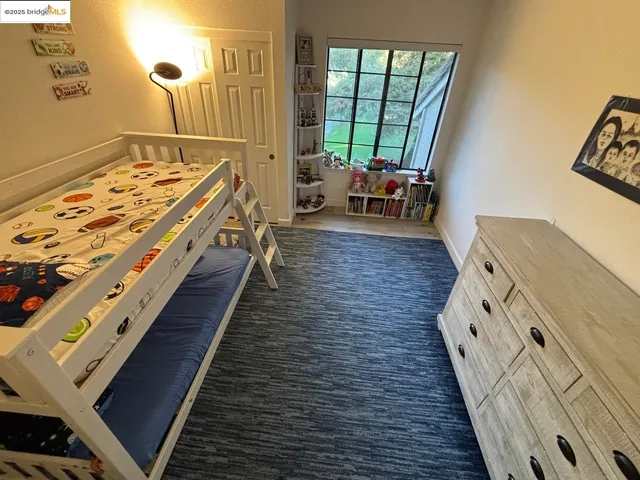 a large white bed in a bathroom next to a window