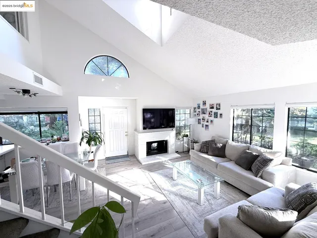 a living room with furniture fireplace and flat screen tv