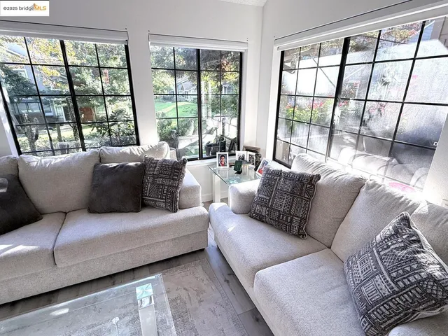 a living room with furniture and large windows