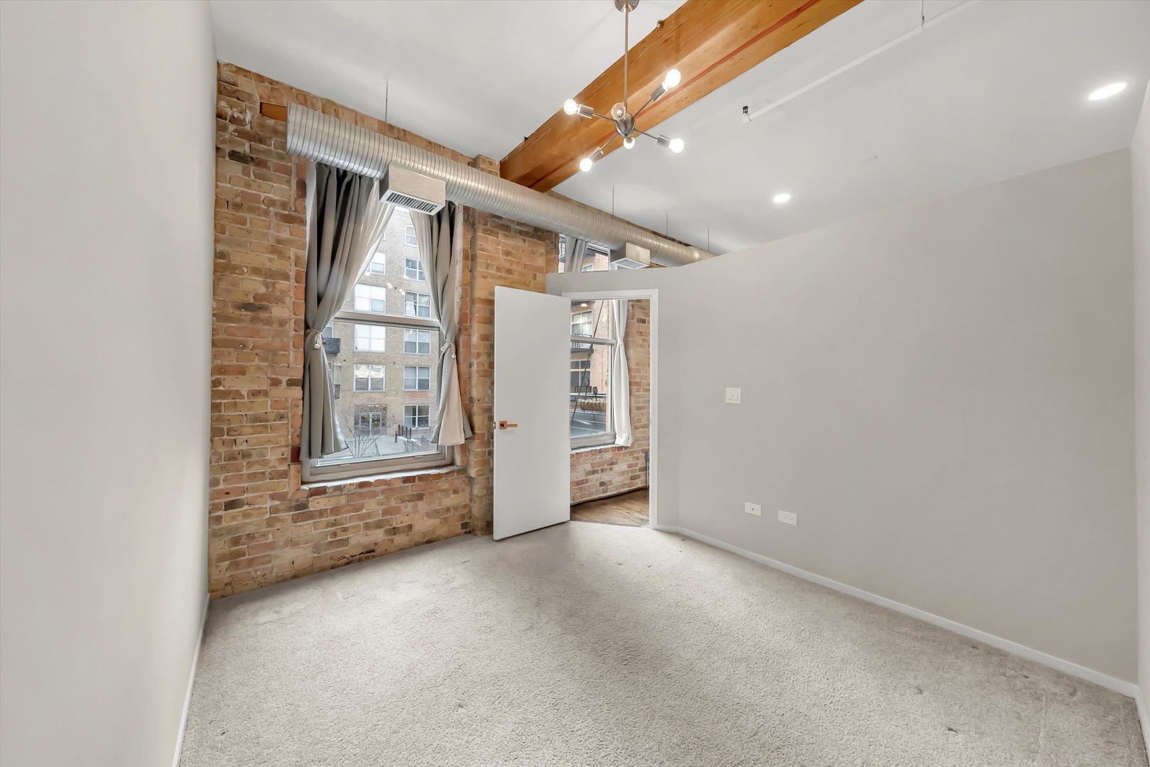 417 South Jefferson Street, Unit 209B Chicago, IL 60607 - Photo 14 of 21 an empty room with windows