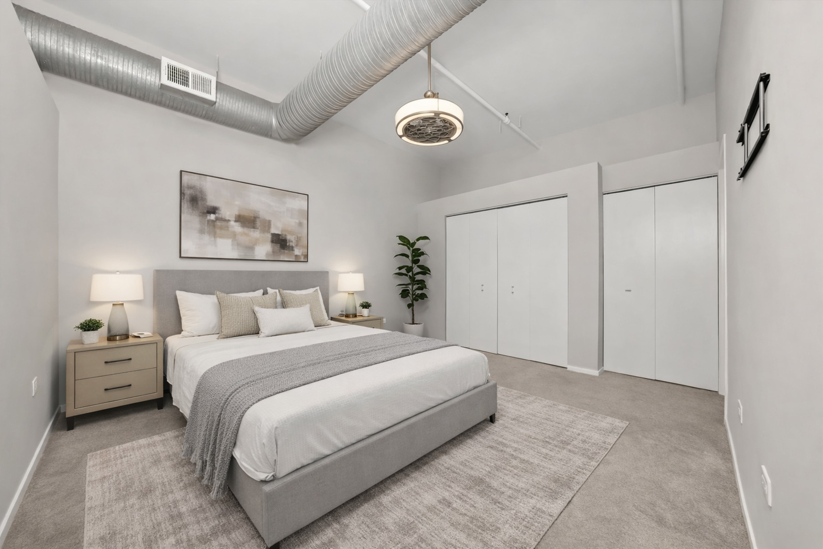 417 South Jefferson Street, Unit 209B Chicago, IL 60607 - Photo 9 of 21 a spacious bedroom with a bed and a painting on the wall