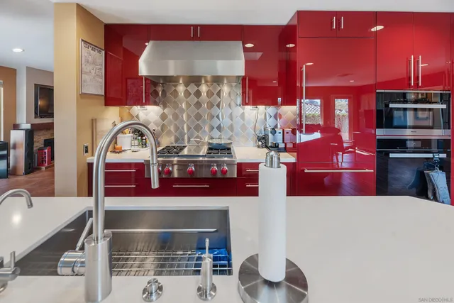 a kitchen with stainless steel appliances kitchen island granite countertop a stove a kitchen island a sink and cabinets