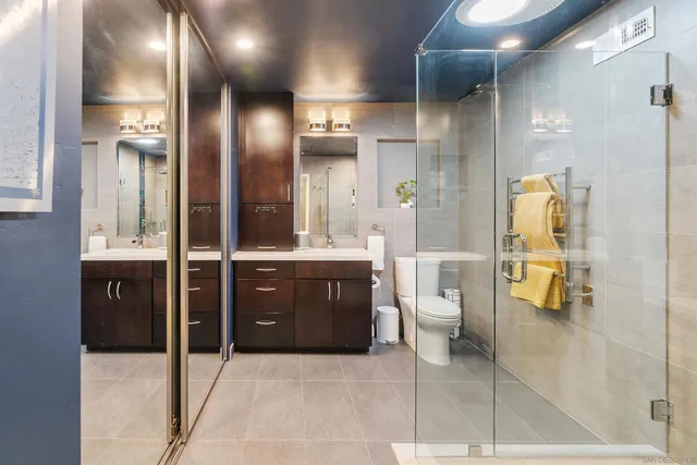 a bathroom with a toilet a sink and mirror