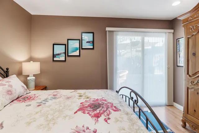 a bedroom with a bed and a large window