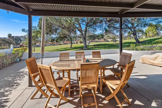 a patio with yard glass top table and chairs