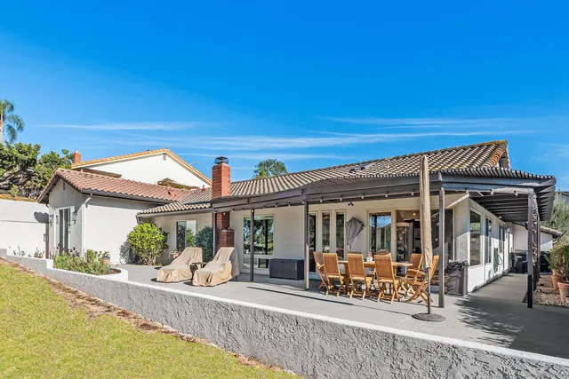 a view of a house with sitting area and swimming pool