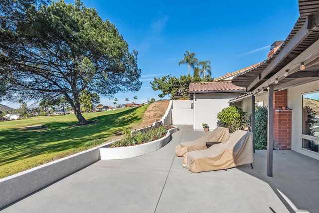 a view of a patio with a table and chairs