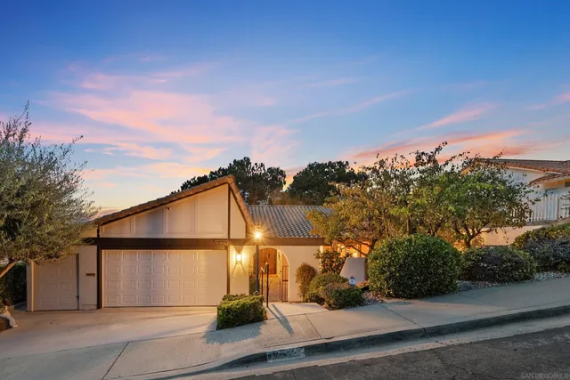a view of a street with wooden fence