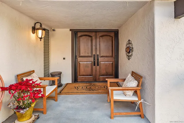 a living room with furniture and flowers