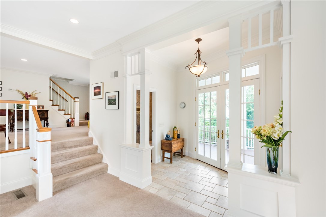 71 Wagner Road Westerly, RI 02891 - Photo 13 of 37 The entry is thoughtfully crafted, with columns, a tiled floor, half bath, and angled french doors that welcome you in to the home, or out to the front porch.