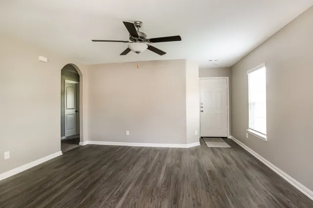 wooden floor in an empty room with a window