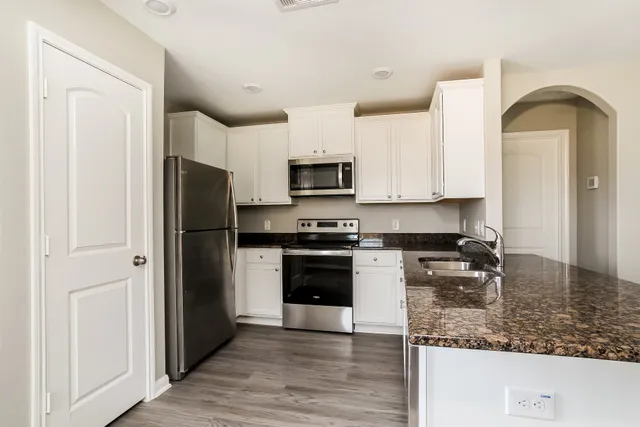 a kitchen with a refrigerator stove and microwave