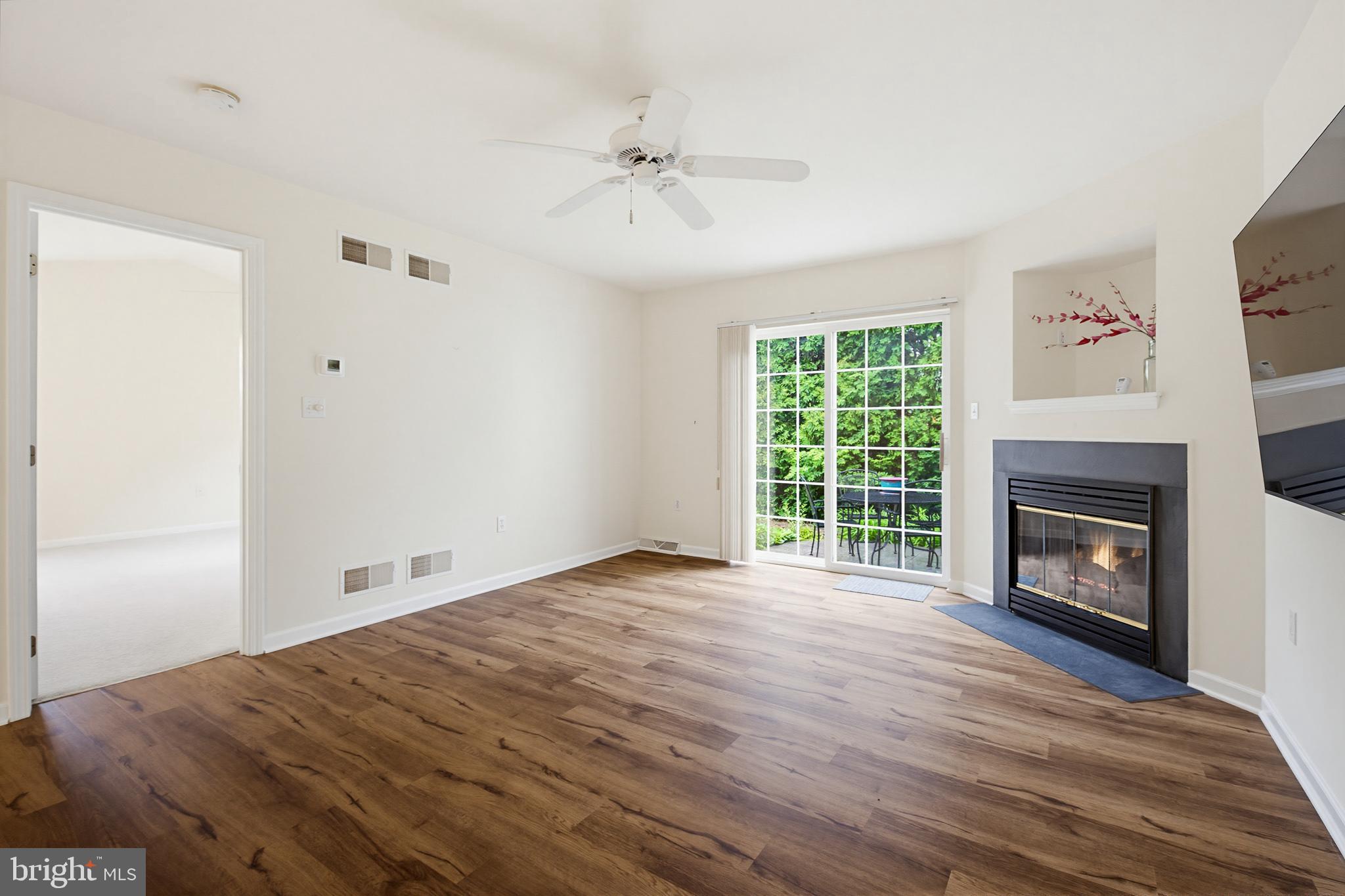 1037 Kent Garden Lititz, PA 17543 - Photo 16 of 31 a view of empty room with wooden floor fireplace and windows