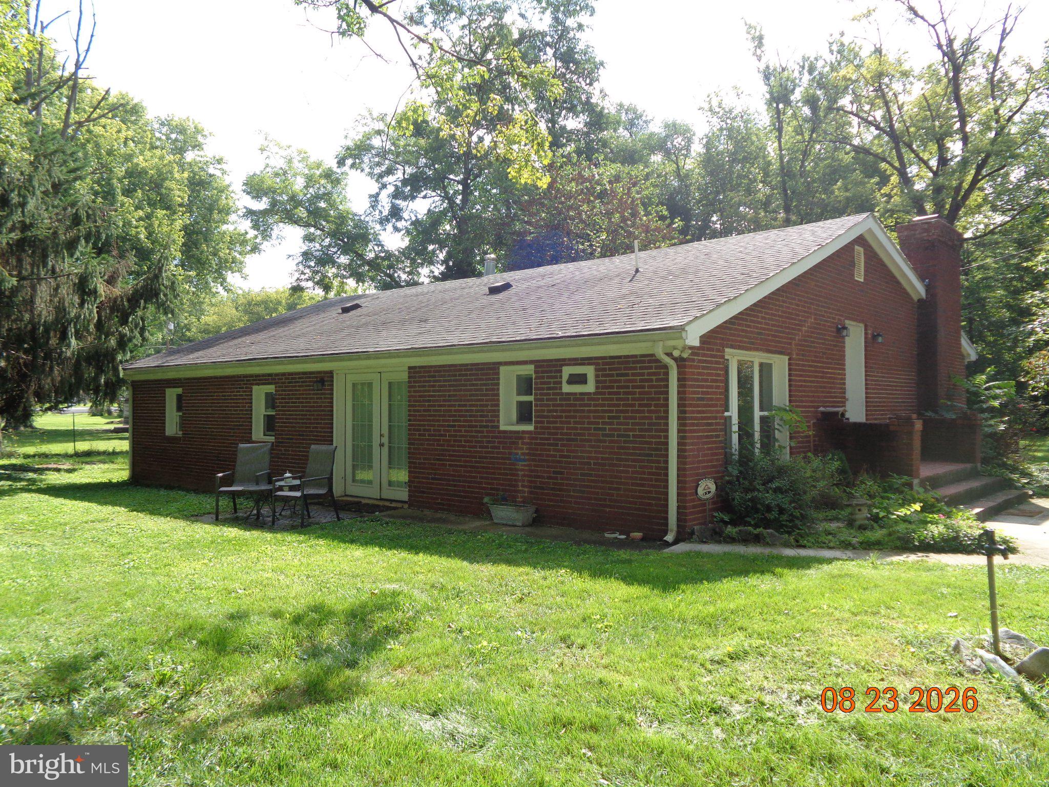 266 Thomson Street Summit Point, WV 25446 - Photo 1 of 3 Charming brick home in lush greenery.