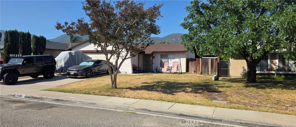 1548 Ranch Road San Bernardino, CA 92407 - Photo 2 of 26 a front view of a house with street