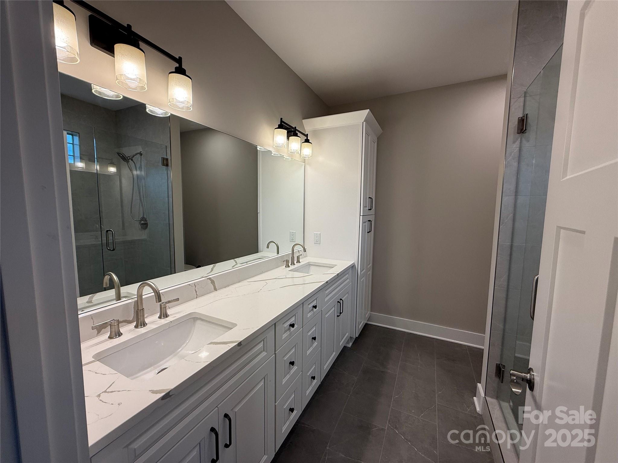 20 Craftsman Overlook Ridge Arden, NC 28704 - Photo 12 of 16 a bathroom with a double vanity sink and mirror with shower