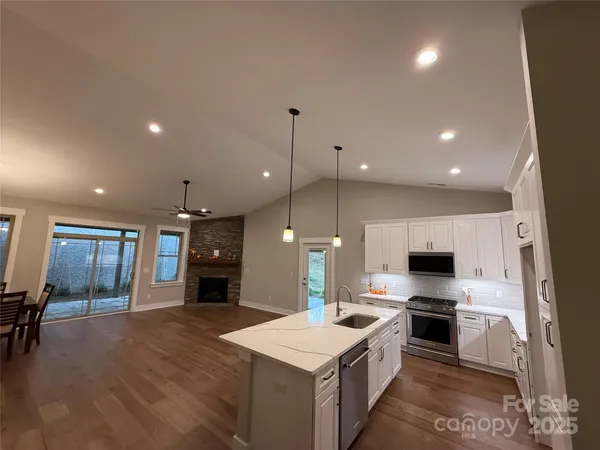 a large kitchen with a large counter top appliances and cabinets