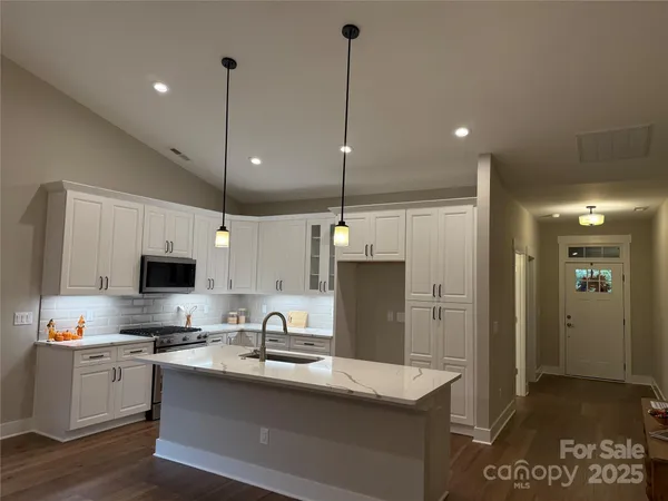 a kitchen with refrigerator and cabinets