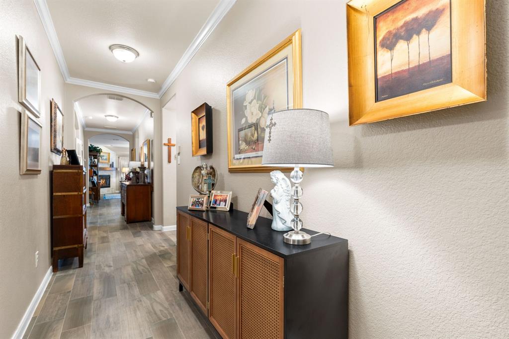 300 Copper Switch Drive Anna, TX 75409 - Photo 16 of 26 A spacious hallway featuring light-toned walls, ceiling crown molding, and tiled flooring