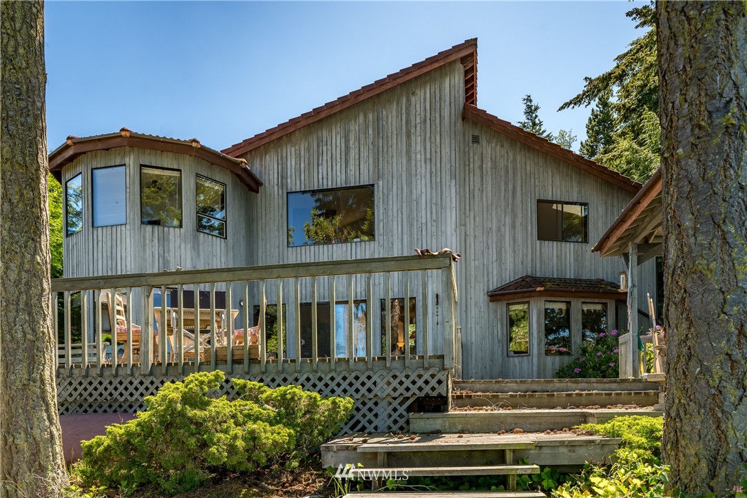 214 Doe Run Road Lopez Island, WA 98261 - Photo 1 of 1 a front view of a house with a garden