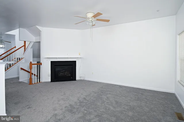 a view of an empty room with a fireplace