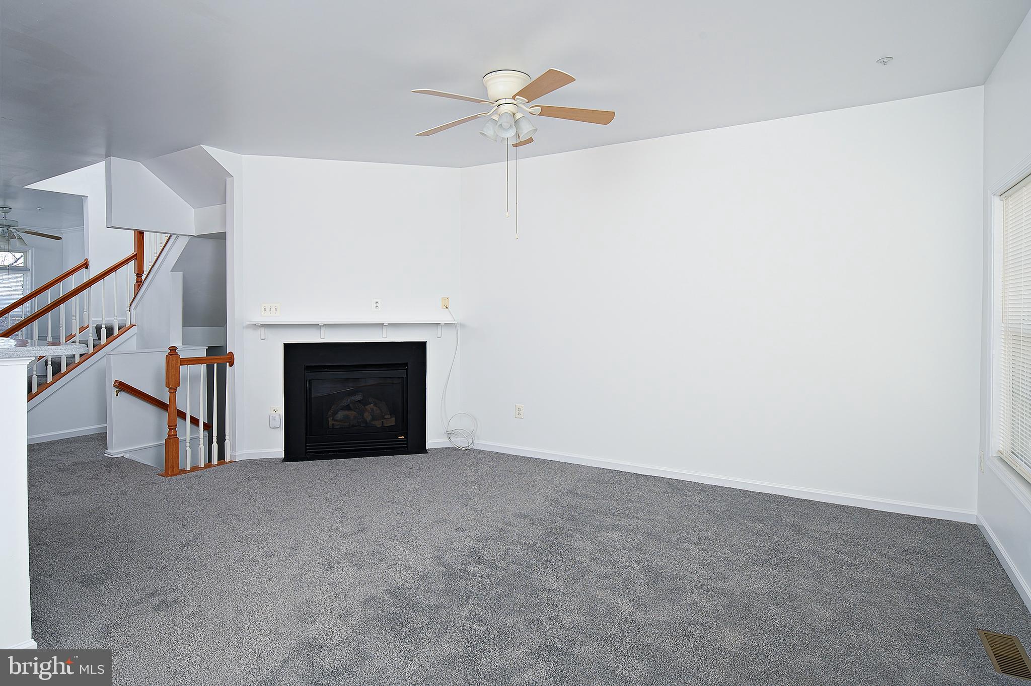 10229 Brighton Ridge Way, Unit 116 Columbia, MD 21044 - Photo 12 of 31 a view of an empty room with a fireplace