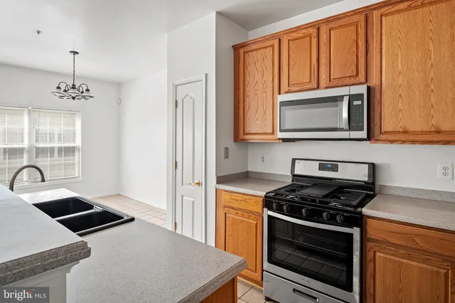 a kitchen with granite countertop a stove and a sink