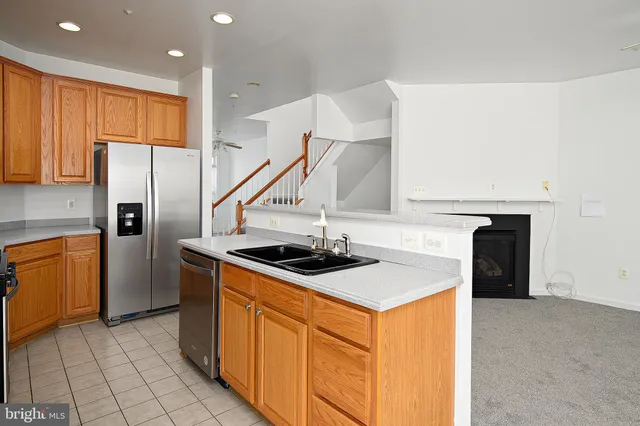 a kitchen with stainless steel appliances a stove a sink and a refrigerator