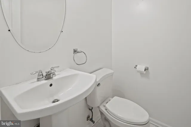 a bathroom with a sink mirror and toilet