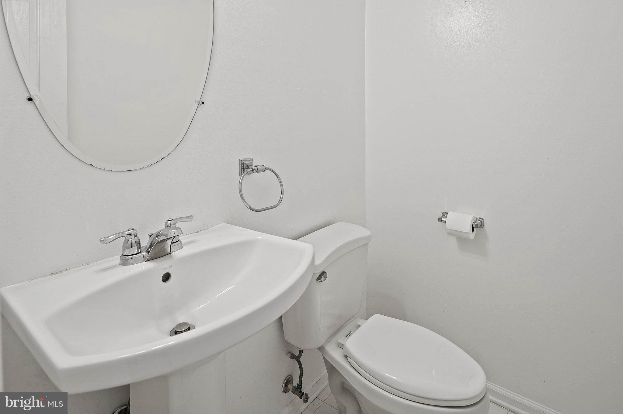 10229 Brighton Ridge Way, Unit 116 Columbia, MD 21044 - Photo 18 of 31 a bathroom with a sink mirror and toilet