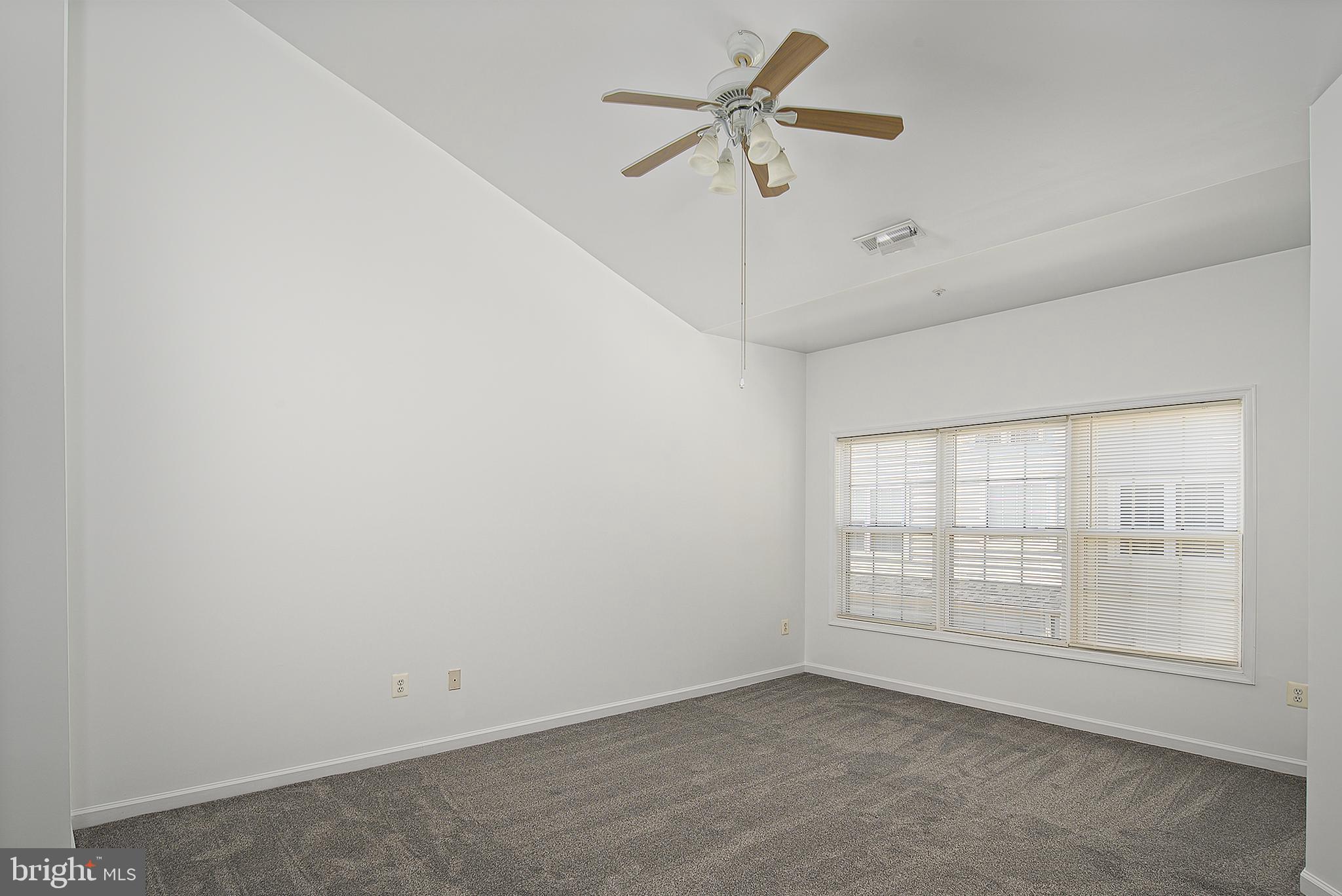 10229 Brighton Ridge Way, Unit 116 Columbia, MD 21044 - Photo 20 of 31 an empty room with windows and fan
