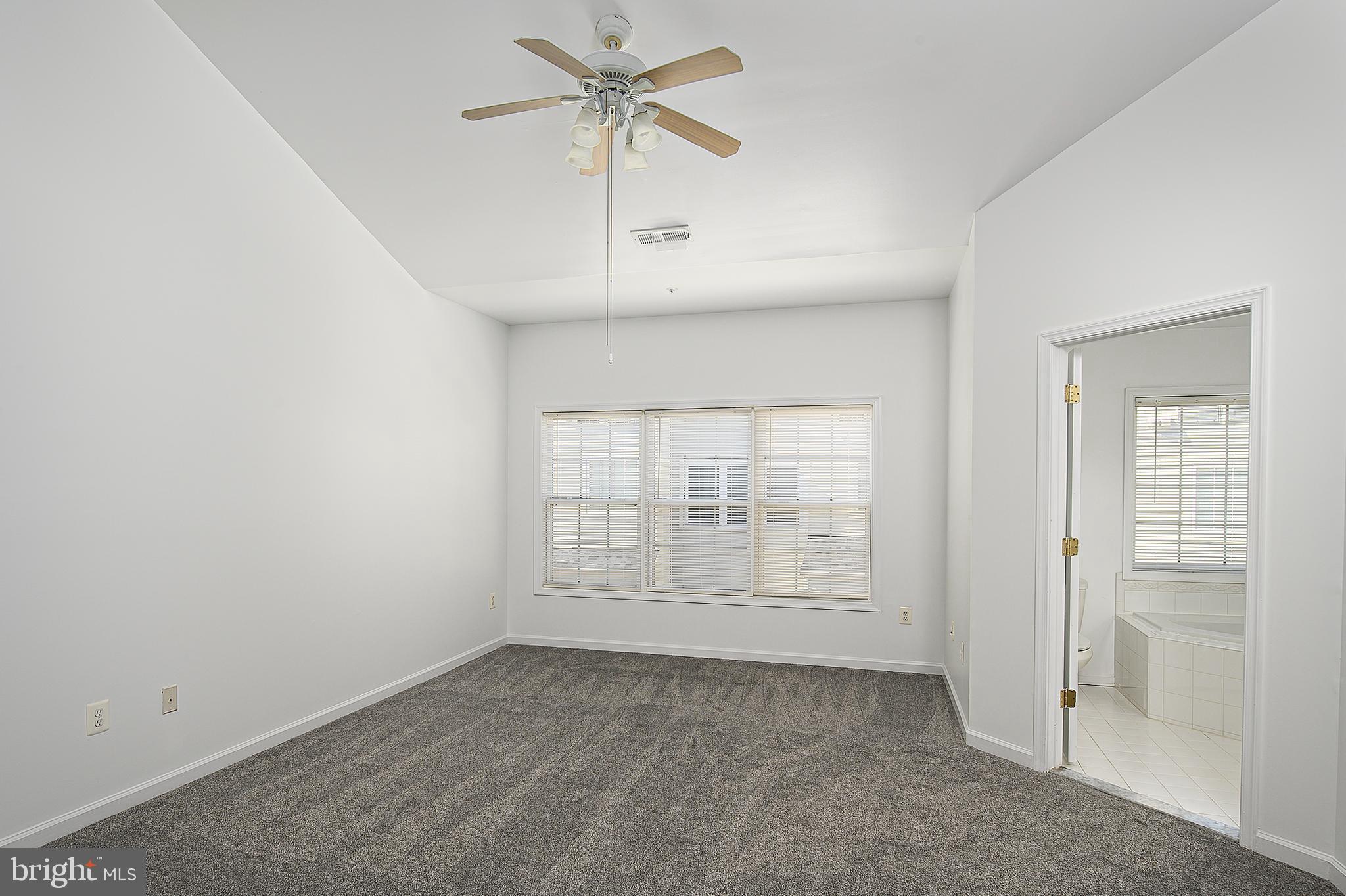 10229 Brighton Ridge Way, Unit 116 Columbia, MD 21044 - Photo 21 of 31 an empty room with windows and fan