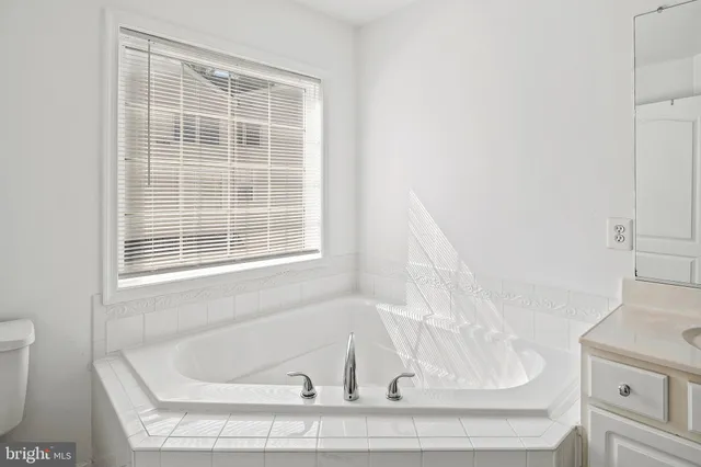 a bathroom with bathtub and window
