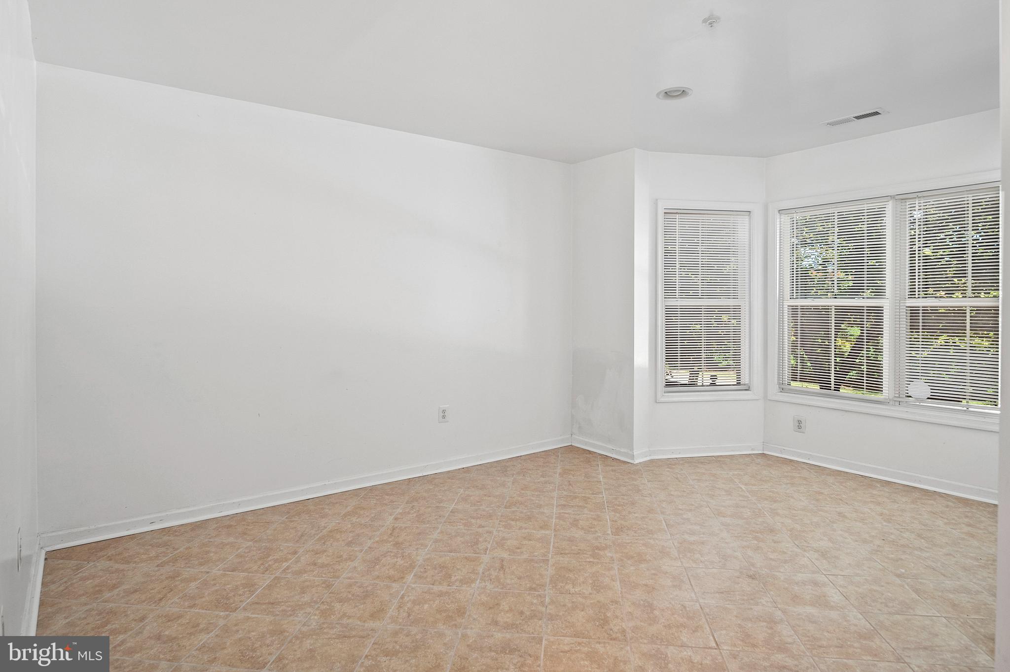 10229 Brighton Ridge Way, Unit 116 Columbia, MD 21044 - Photo 6 of 31 an empty room with windows