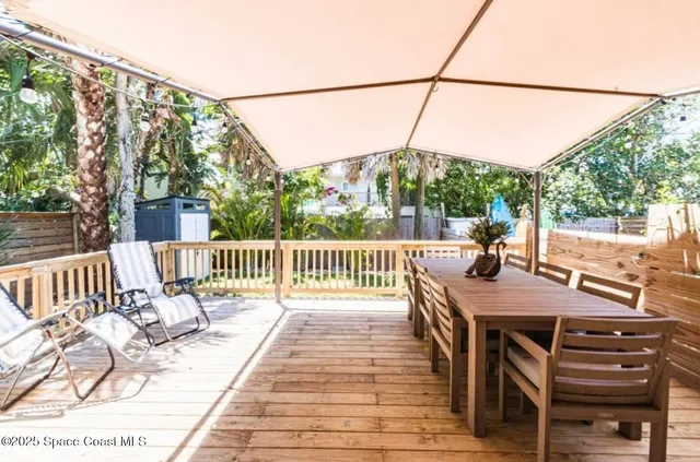 a view of a patio with wooden floor