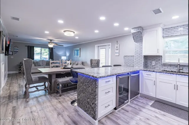 a large kitchen with lots of counter space dining table and chairs