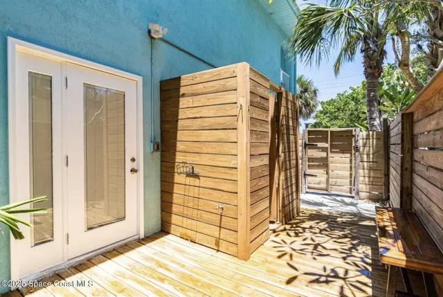 a view of a house with a door and wooden walls