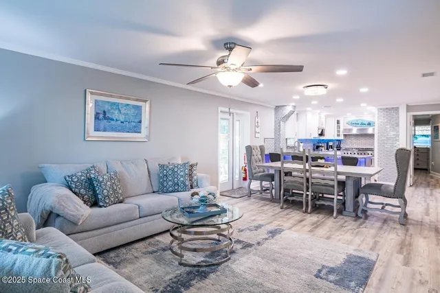 a living room with furniture kitchen view and a dining table