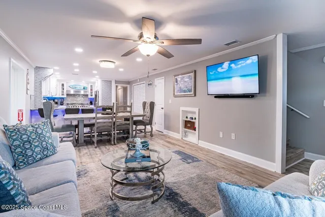 a living room with lots of furniture and view of kitchen